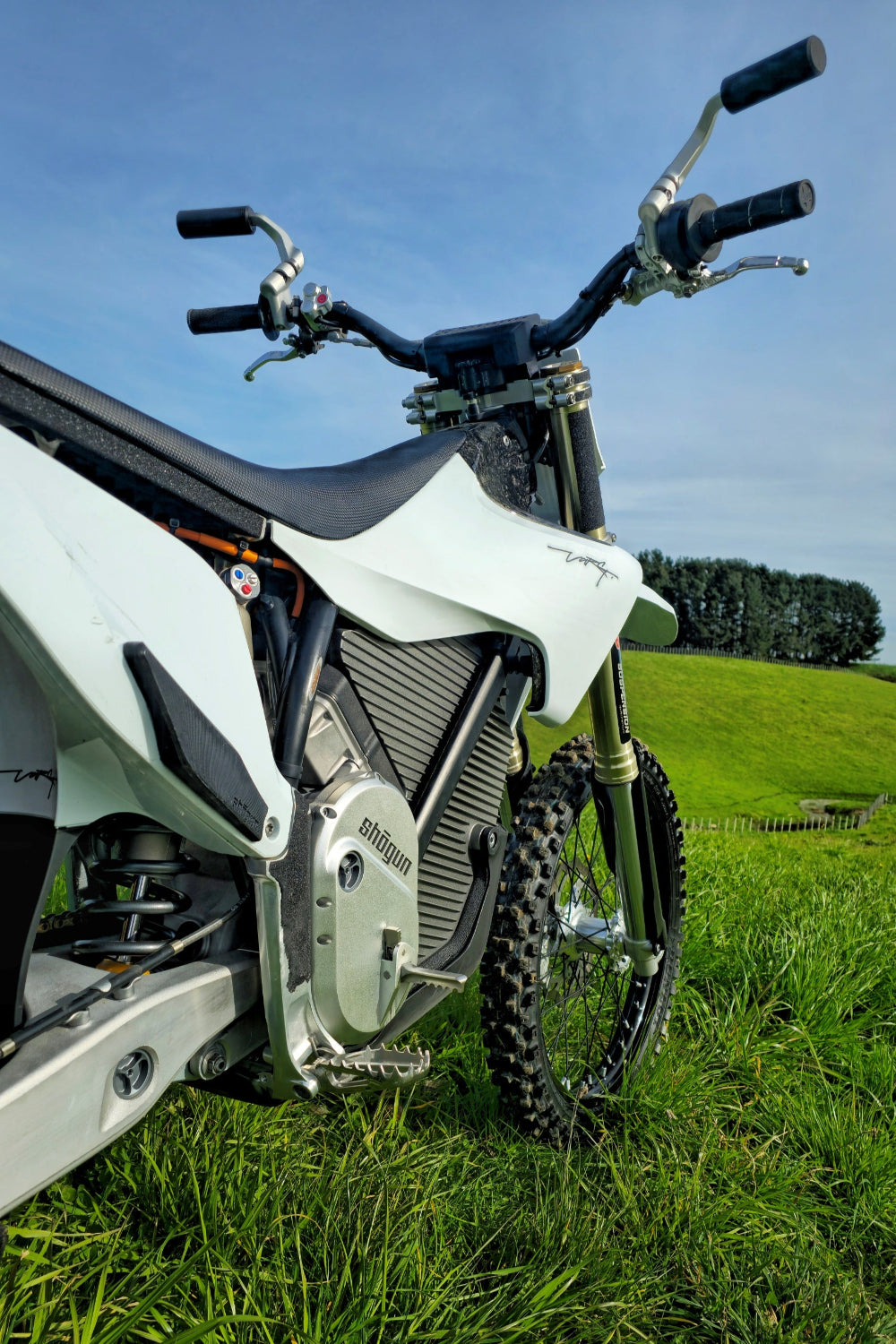 Detailed view of the Shogun foot hook installed on the right side of the Stark VARG electric dirt bike