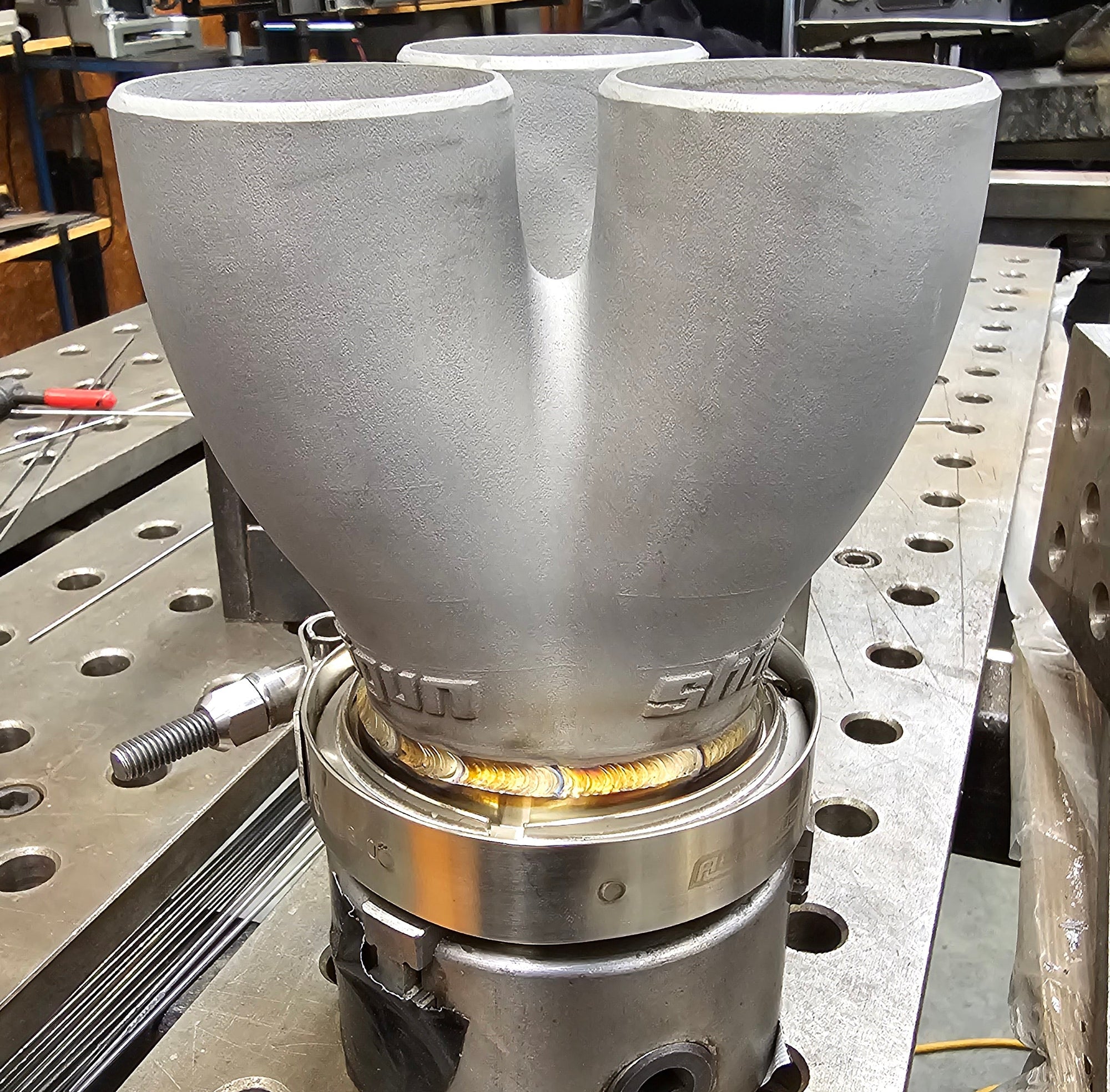 Stainless steel 3D printed exhaust collector welded to V-band flange, forming the outlet of the high performance manifold system