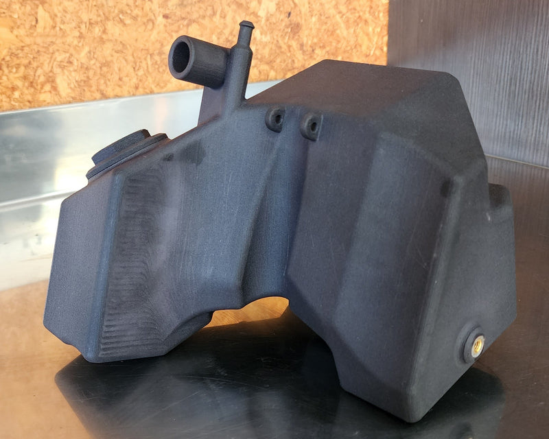 SLS 3D printed nylon fuel tank for a custom FMX motorcycle with central placement, fuel sight, and integrated breather routing