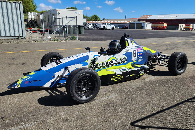 Blake Dowdall seated in his Formula Ford race car featuring a custom 3D printed cold air intake integrated into the tight engine bay and bodywork