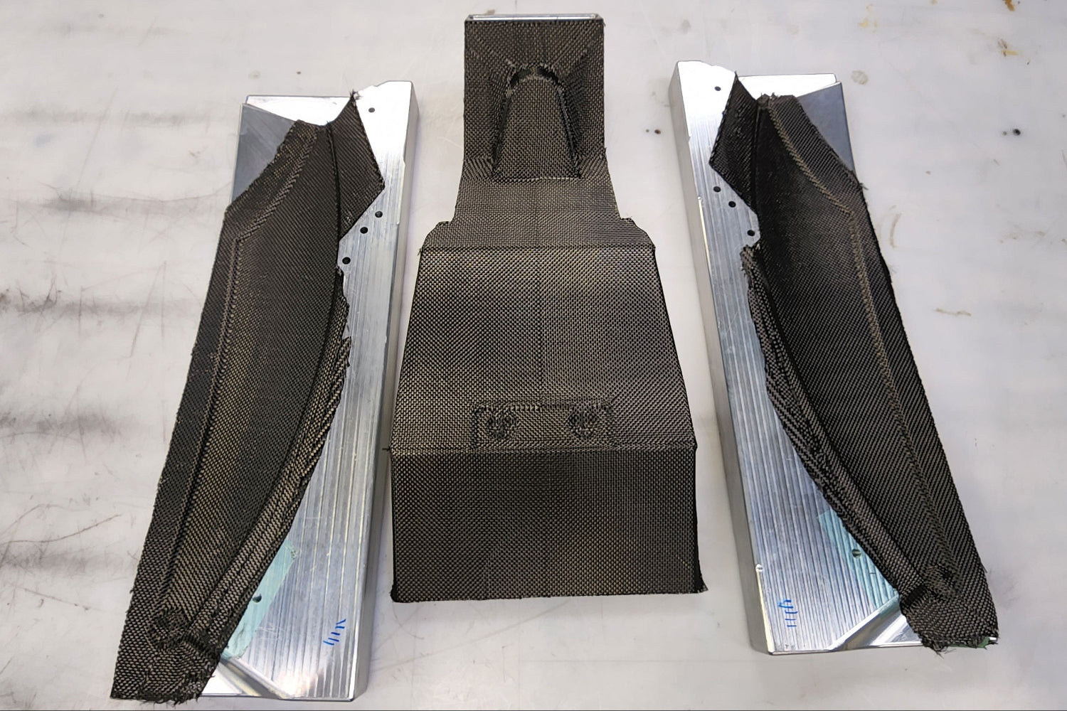 Carbon fiber subframe section being laid up in a split billet aluminum mold for the Shogun FMX Bike
