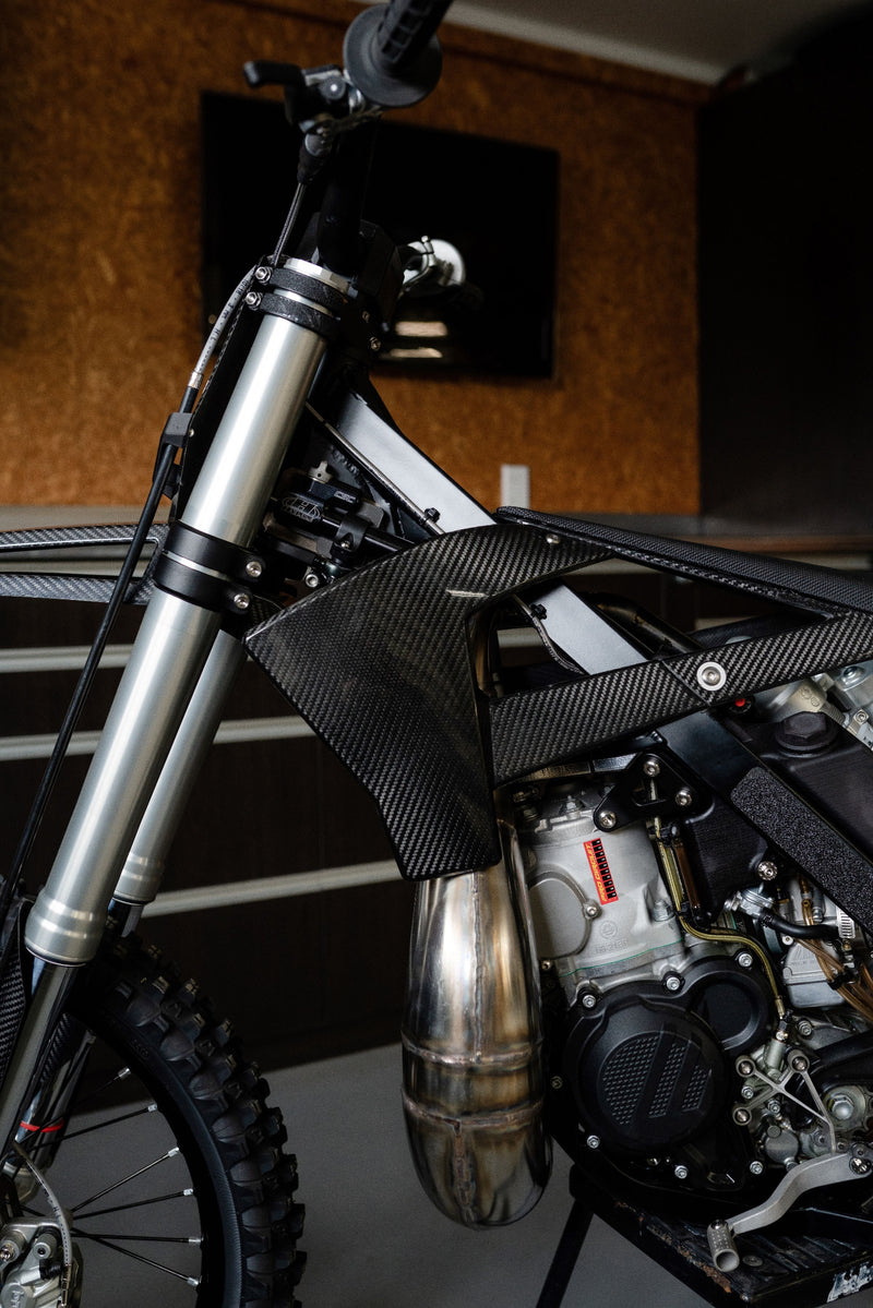 Custom carbon fibre shrouds fitted to the Shogun FMX Bike showing the lightweight design and open airflow layout