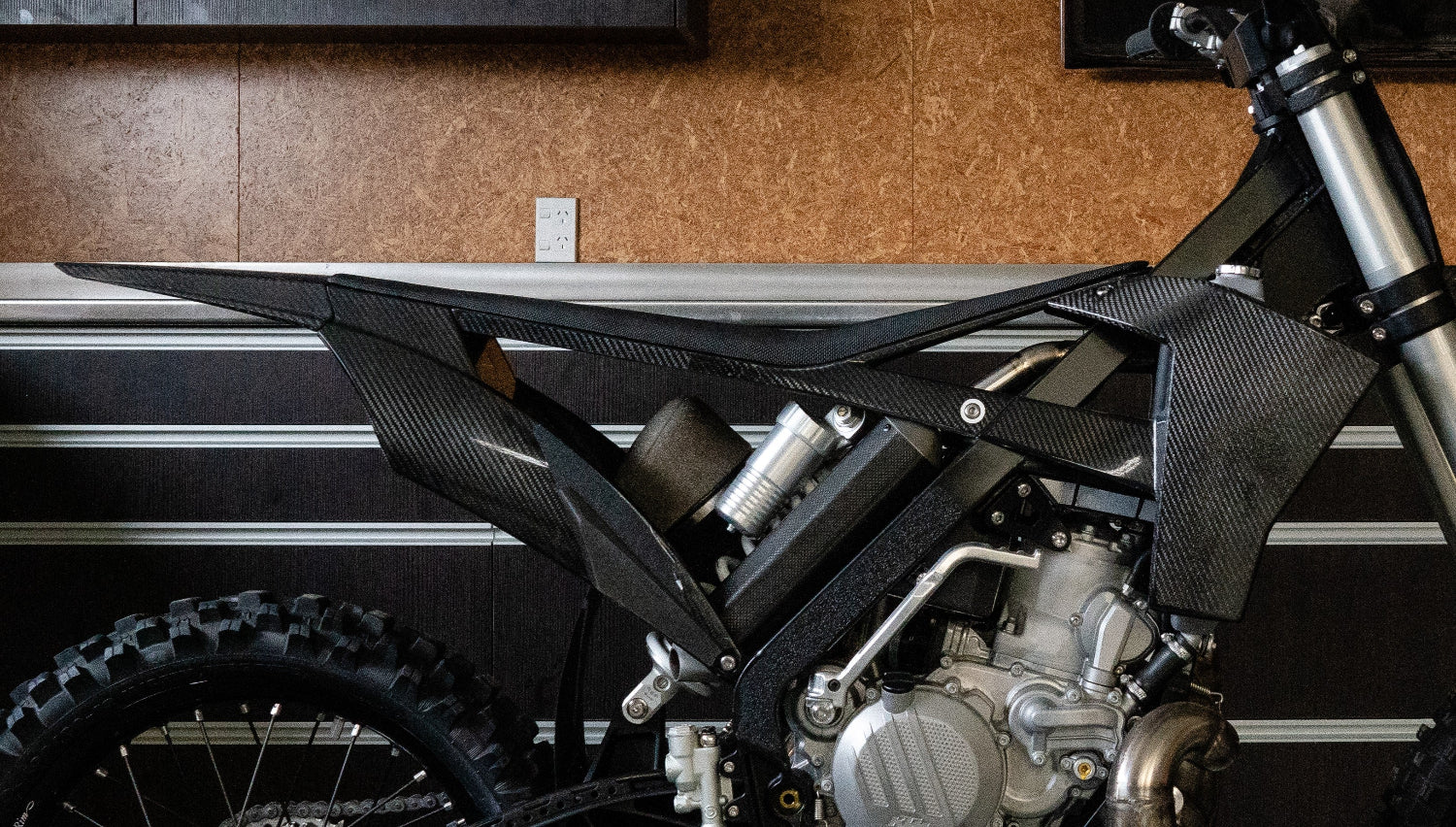 Close up side view of the Shogun FMX Bike showing the carbon fibre subframe structure and lower side plates designed for strength, airflow, and rider control