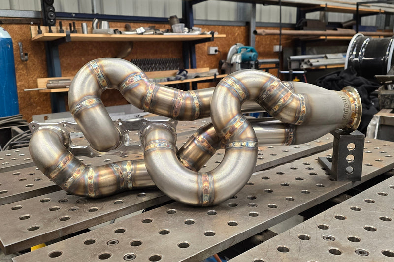 Fully assembled high performance exhaust manifold with equal length runners, stainless collector and V-band outlet ready for installation