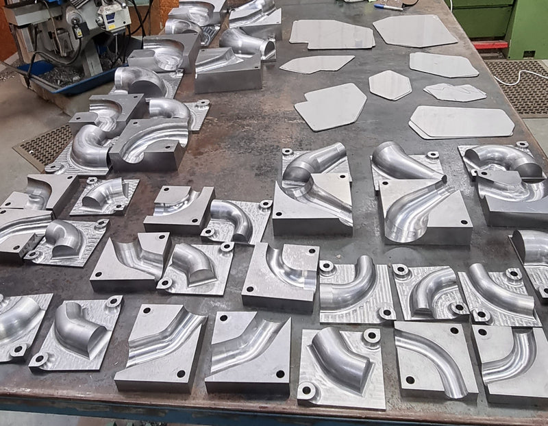 CNC machined steel press forms used to shape the stainless steel expansion chamber for the Shogun FMX Bike exhaust system