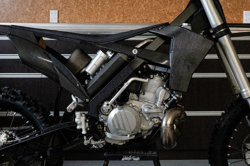 Custom titanium and carbon fibre silencer designed for the Shogun FMX Bike to improve packaging, centralise mass, and reduce weight