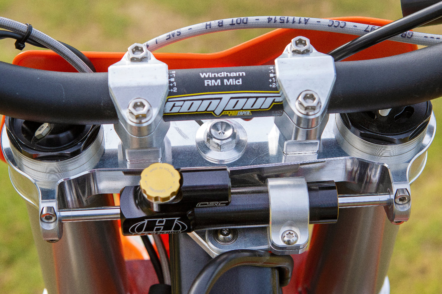 Custom triple clamp and integrated steering stabilizer linkage developed for a FMX Bike