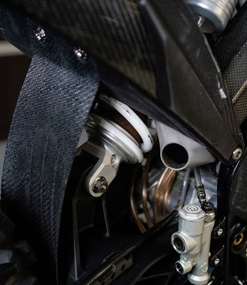Custom silencer exit positioned behind the rider’s foot on the Shogun FMX Bike for compact routing and balanced weight distribution