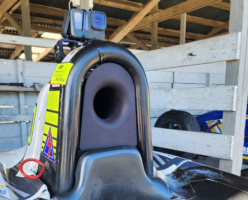 Front angle view of custom cold air intake installed in a Formula Ford car, showing intake opening positioned between bodywork and engine bay for direct airflow