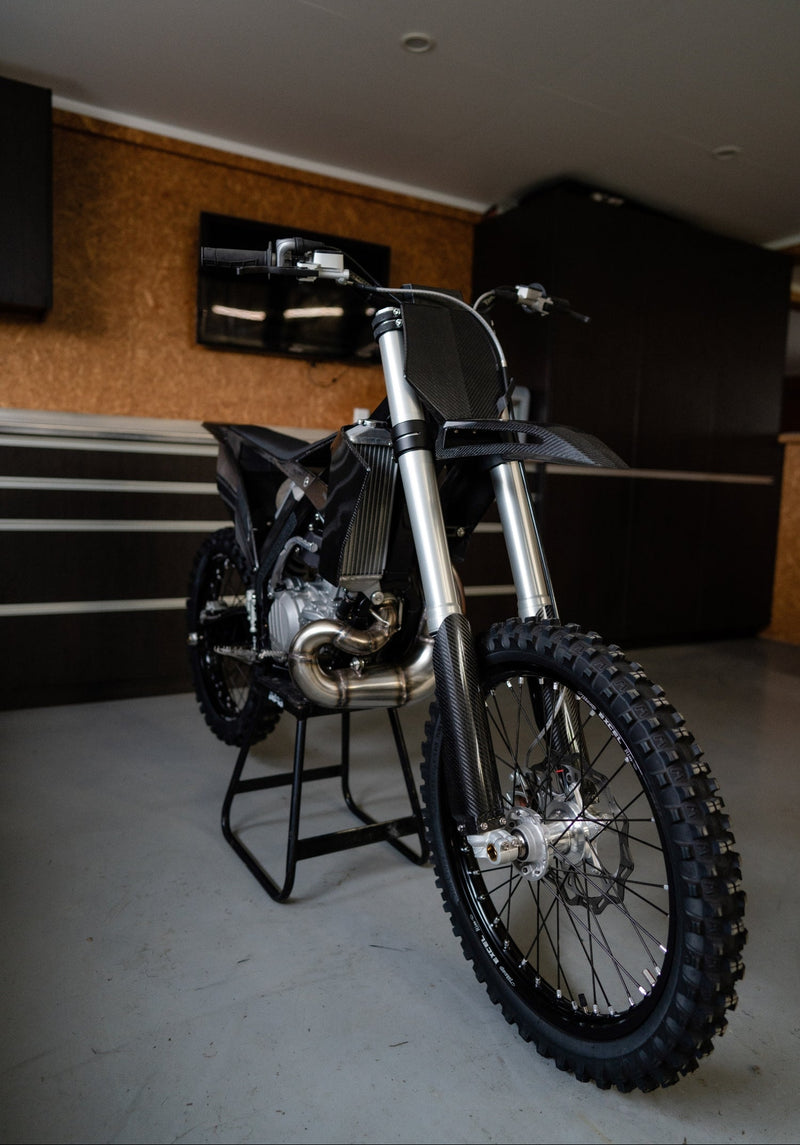 Front angle view of the Shogun FMX Bike showing the custom frame geometry, carbon fibre bodywork, and lightweight front end design
