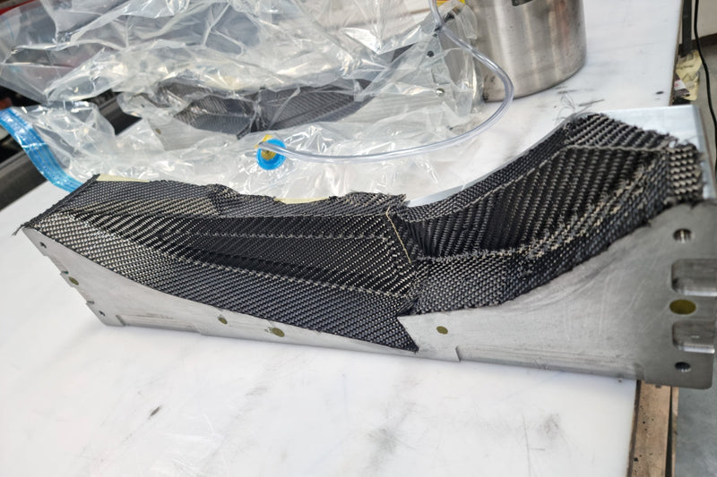 Carbon fibre front fender being laid up in a billet aluminium mould for the Shogun FMX Bike