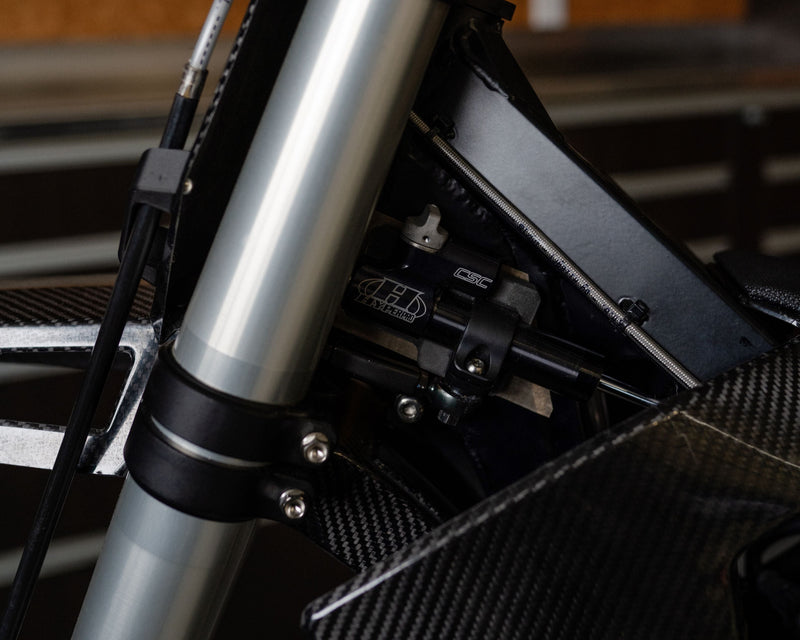 Linear steering damper mounted on the Shogun FMX Bike showing the custom integrated frame and linkage design