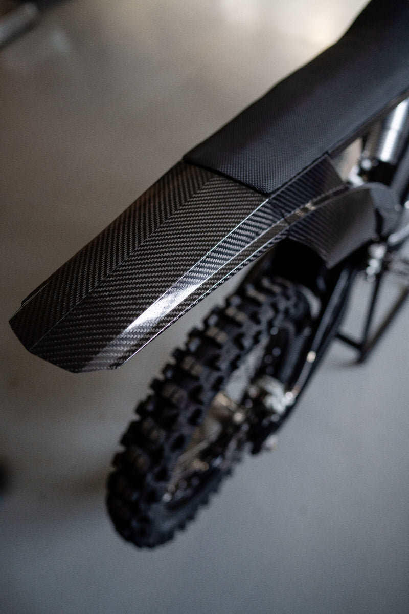 Rear section of the Shogun FMX Bike showing the custom subframe, carbon fibre bodywork, and compact exhaust packaging