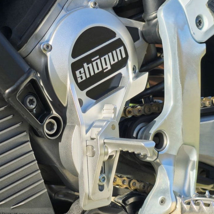 Shogun adjustable foot hook mounted on dirt bike showing fold away design used as fake shift or shift lock for FMX, supermoto and wheelies