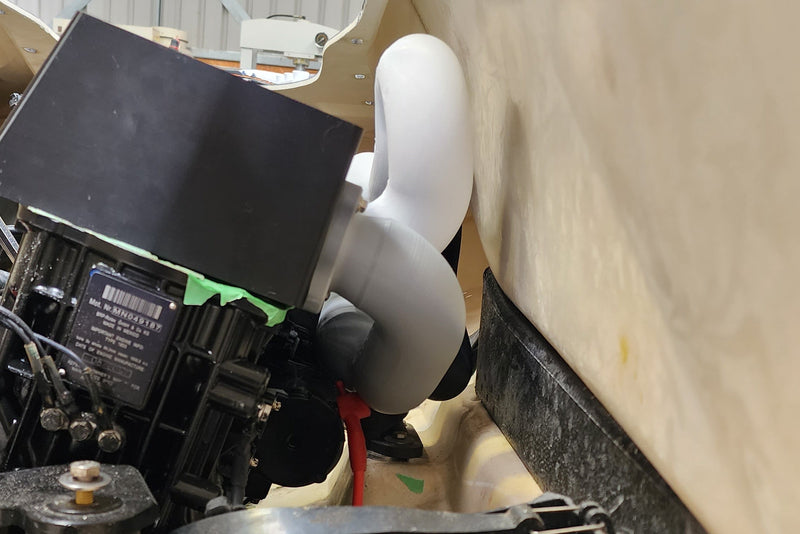 Side view of high performance exhaust manifold showing extremely tight clearance between engine and surrounding components