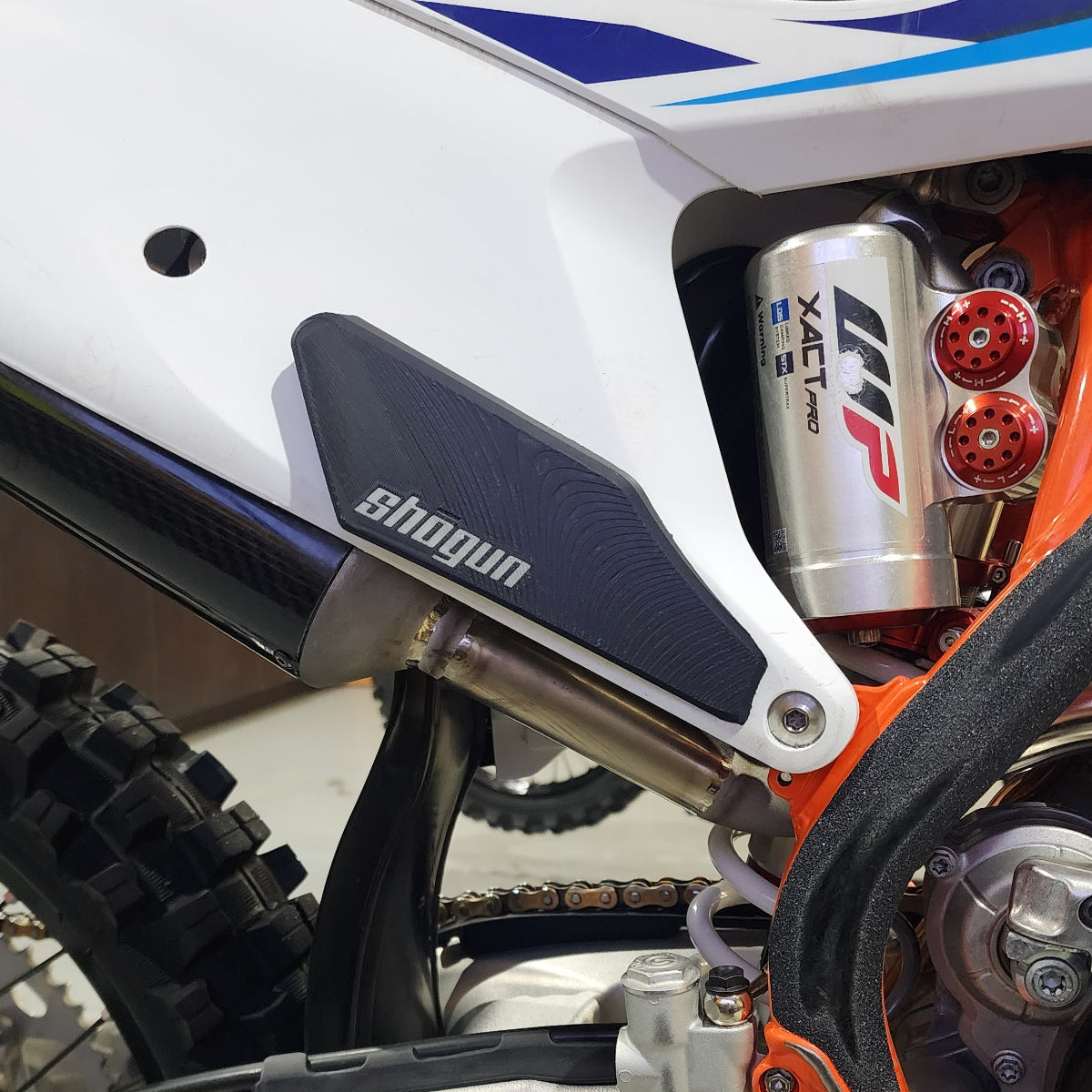 3D printable side plate grips fitted to a KTM dirt bike for improved MX and FMX leg grip